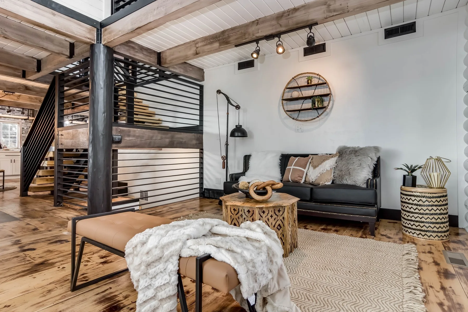 Restored Park City cabin interior with reclaimed beams and a blackened steel stair screen