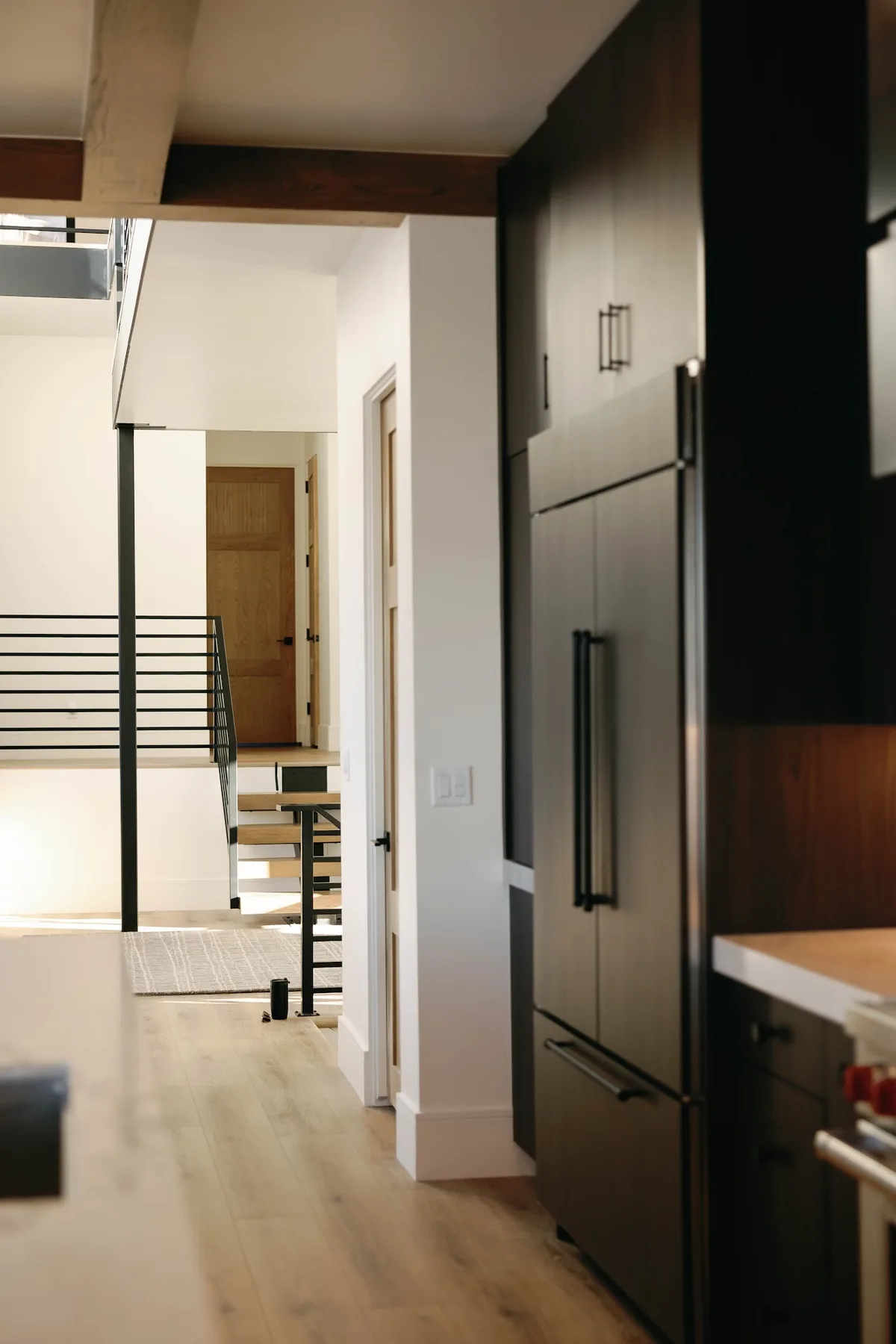 New build interior with white oak floors and dark walnut cabinetry
